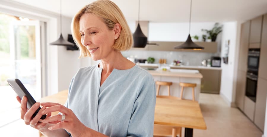Woman with cell phone in a stylish home